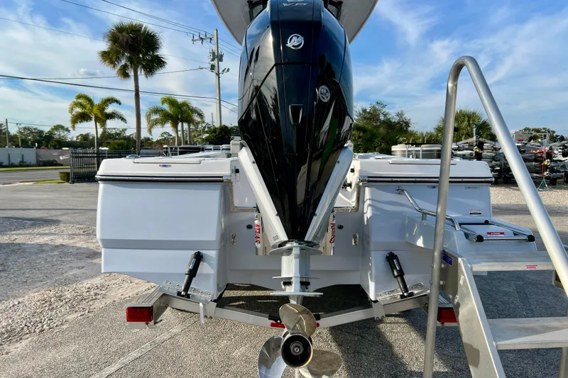 Slide: The Image of 2026 Robalo 246 Cayman boat with powerful outboard motor, parked on a trailer. - 7