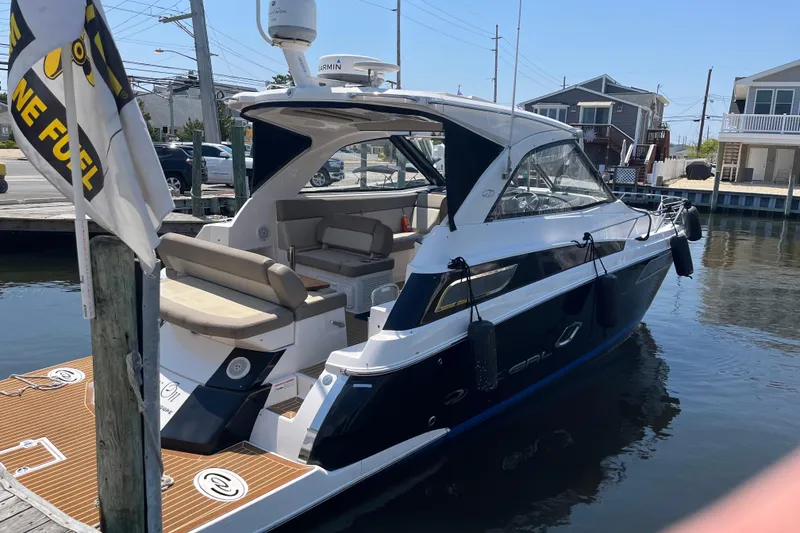 Slide: The Image of 2013 Regal 35 Sport Coupe docked, showcasing sleek design and comfortable seating. - 11