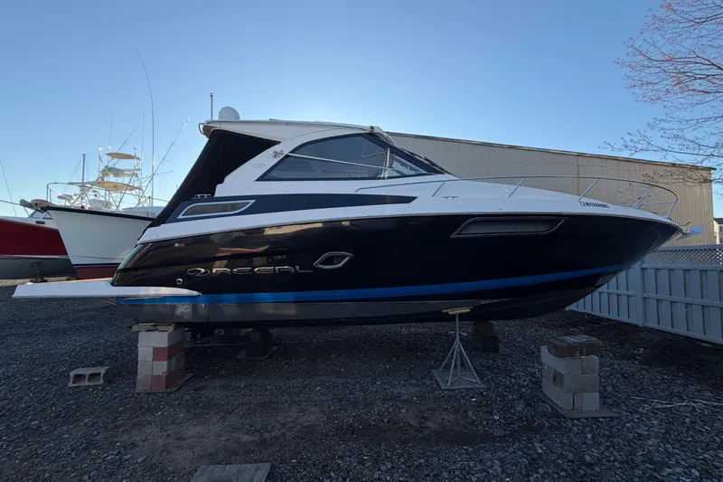 Slide: The Image of 2013 Regal 35 Sport Coupe boat on dry dock, side view. - 13