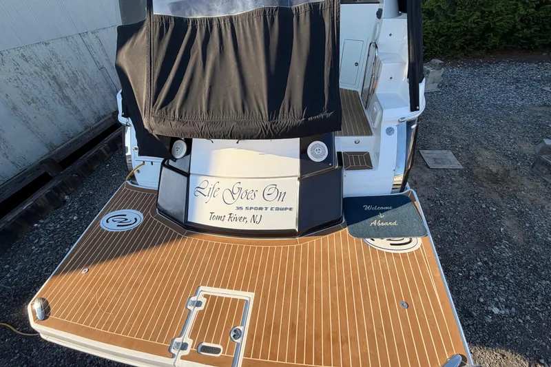 Slide: The Image of 2013 Regal 35 Sport Coupe boat with wooden deck, docked in Toms River, NJ. - 20