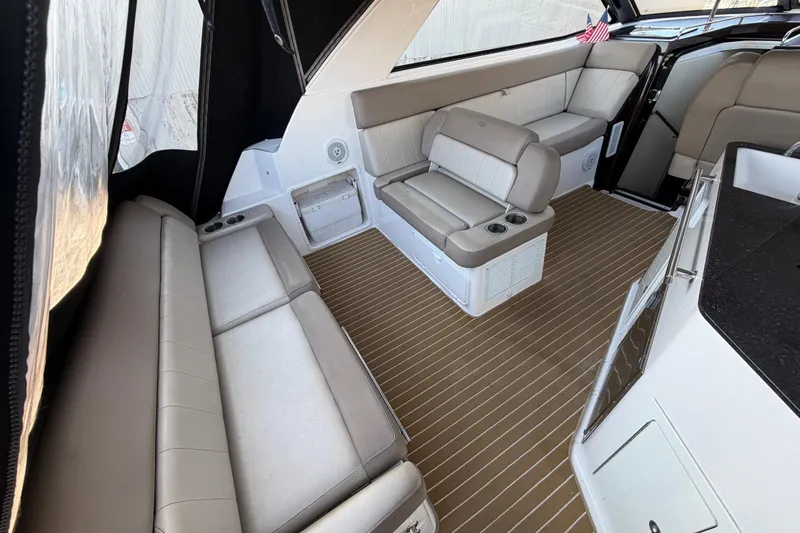 Slide: The Image of Interior of a 2013 Regal 35 Sport Coupe with beige seating and wood-patterned flooring. - 21