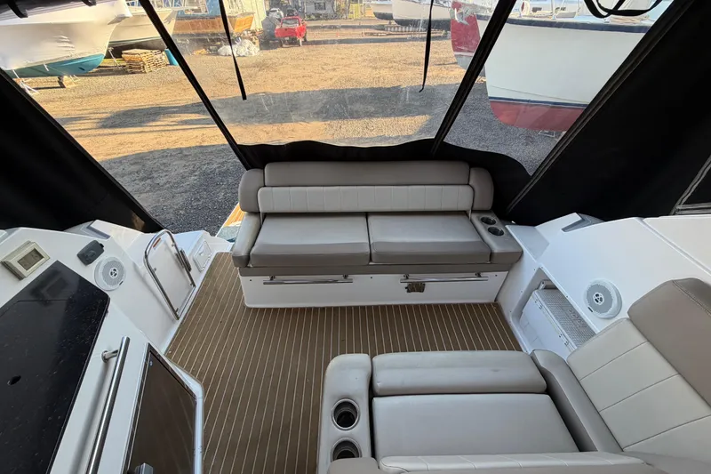 Slide: The Image of Interior of a 2013 Regal 35 Sport Coupe with beige seating and wood flooring. - 22