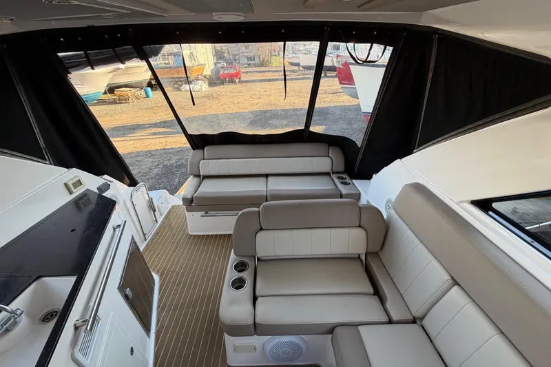 Slide: The Image of Interior of 2013 Regal 35 Sport Coupe with beige seating and kitchenette. - 23