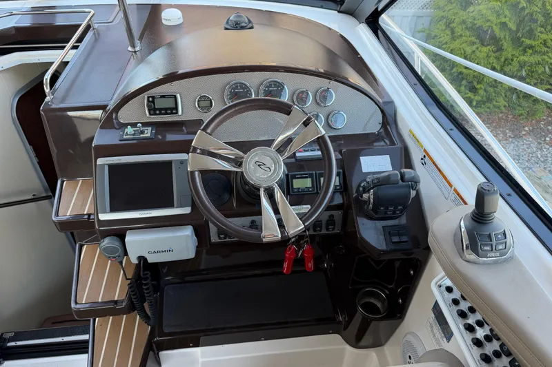 Slide: The Image of Cockpit of 2013 Regal 35 Sport Coupe with steering wheel and navigation controls. - 26