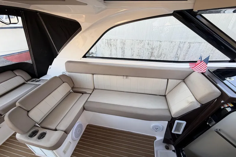 Slide: The Image of Interior of a 2013 Regal 35 Sport Coupe with beige seating and American flag decor. - 28
