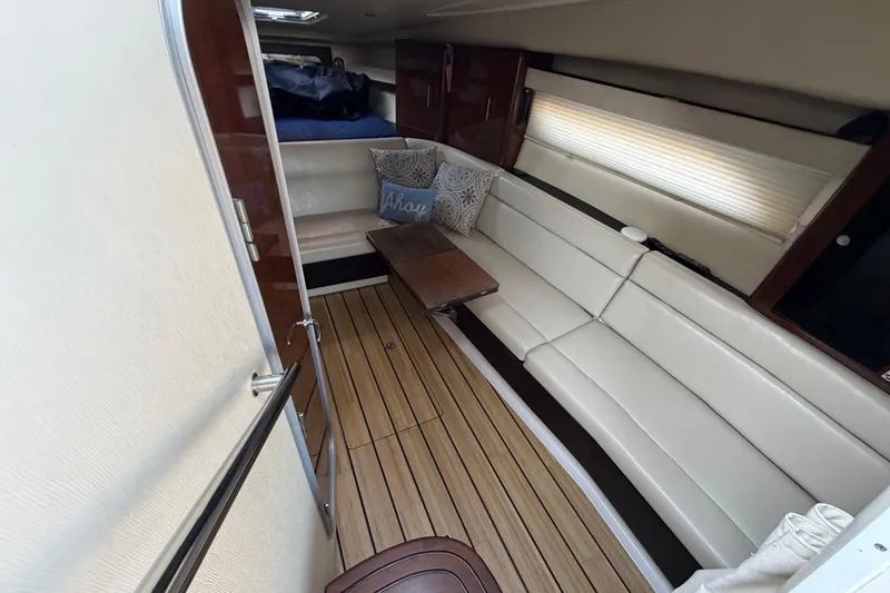 Slide: The Image of Interior of 2013 Regal 35 Sport Coupe with white seating and wooden flooring. - 29