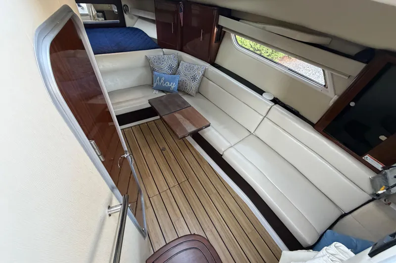 Slide: The Image of Interior of 2013 Regal 35 Sport Coupe with white seating and wooden flooring. - 30