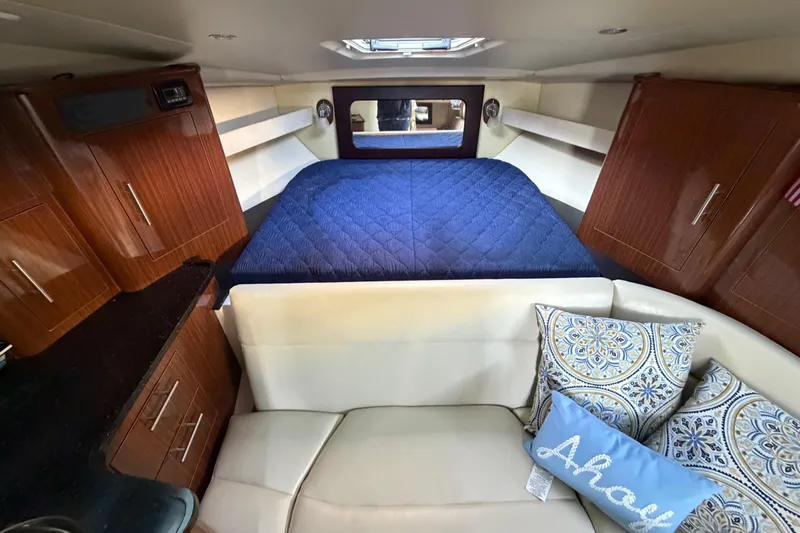 Slide: The Image of Interior of 2013 Regal 35 Sport Coupe with cozy bed and decorative pillows. - 33