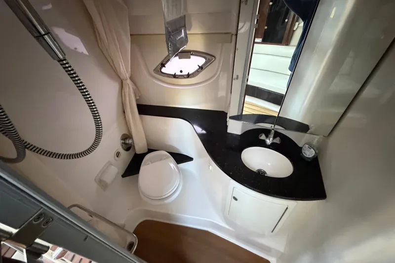 Slide: The Image of Bathroom interior of 2013 Regal 35 Sport Coupe with sink, toilet, and shower. - 34