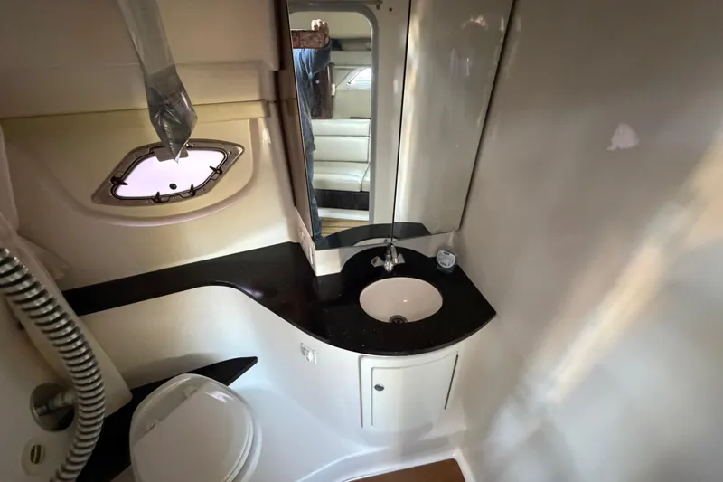 Slide: The Image of Bathroom interior of 2013 Regal 35 Sport Coupe with sink, mirror, and porthole window. - 36