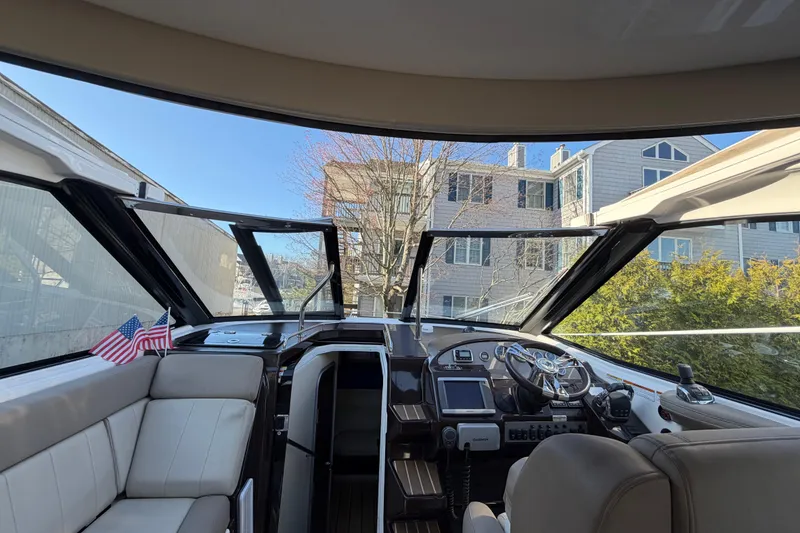 Slide: The Image of Interior view of 2013 Regal 35 Sport Coupe yacht cockpit with steering wheel and seating. - 38