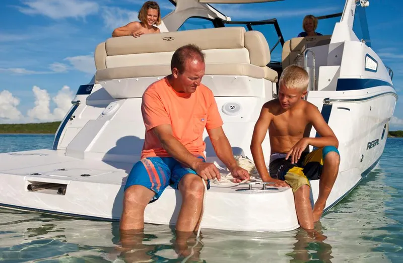 Slide: The Image of Manufacturer Provided Image: Family enjoying time on a 2013 Regal 35 Sport Coupe boat in shallow water. - 4