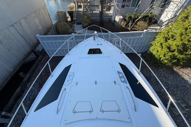 Slide: The Image of 2013 Regal 35 Sport Coupe boat docked near waterfront home. - 40