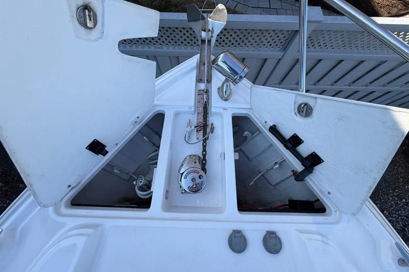 Slide: The Image of Anchor compartment of a 2013 Regal 35 Sport Coupe boat with open hatches. - 41