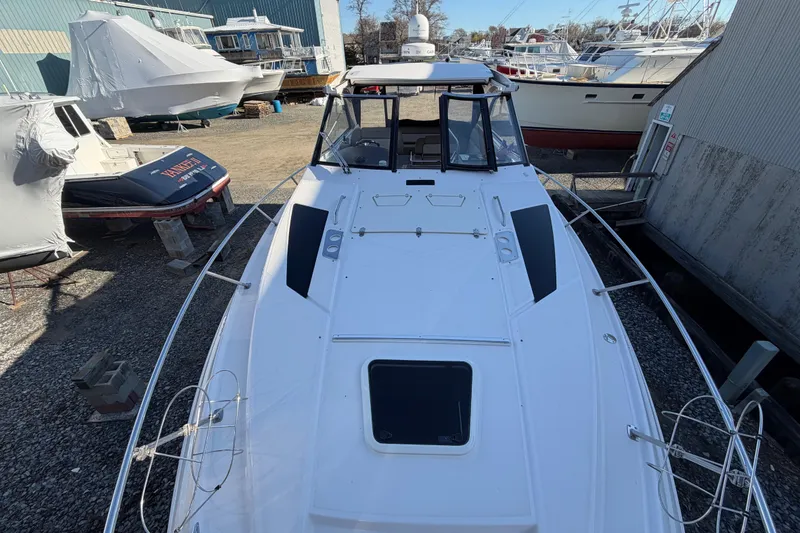 Slide: The Image of 2013 Regal 35 Sport Coupe boat docked in a marina, top view. - 44
