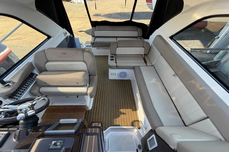 Slide: The Image of Interior of a 2013 Regal 35 Sport Coupe with beige seating and wood accents. - 45