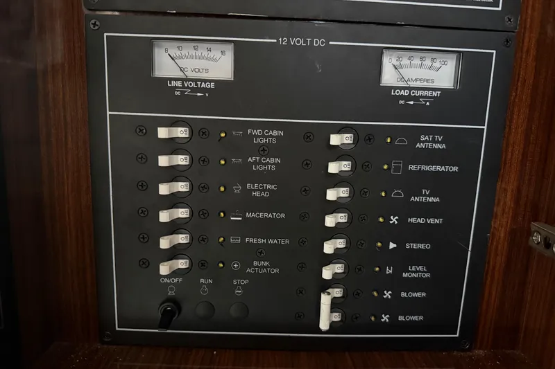Slide: The Image of Control panel of a 2013 Regal 35 Sport Coupe, featuring switches and voltage meters. - 46