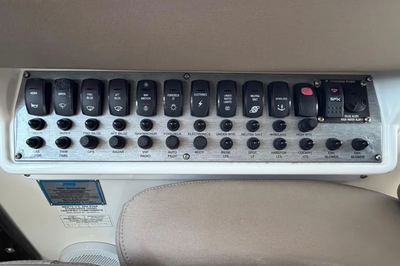 Slide: The Image of Control panel of a 2013 Regal 35 Sport Coupe boat with labeled switches and buttons. - 48