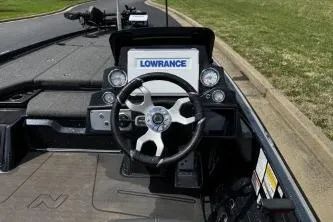Slide: The Image of 2023 Nitro Z21 XL boat dashboard with Lowrance display and steering wheel. - 11