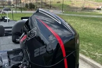 Slide: The Image of 2023 Nitro Z21 XL boat engine with red accents, parked on grass. - 6