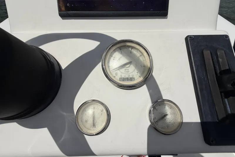 Slide: The Image of Dashboard of a 2017 Beavertail Skiffs Lightning with gauges and controls. - 14