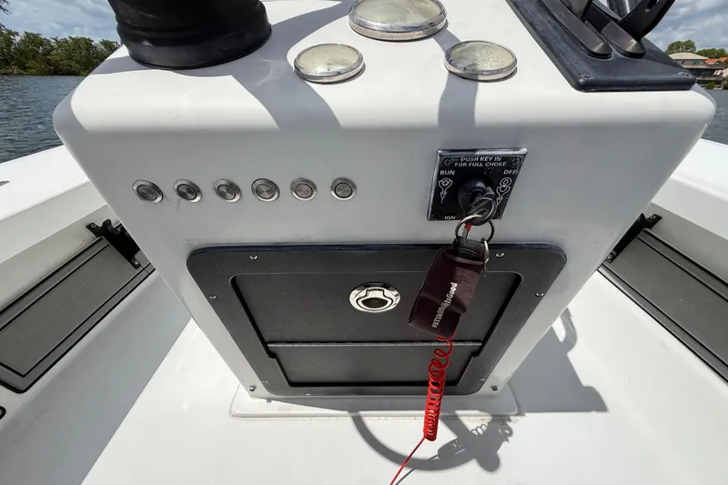 Slide: The Image of 2017 Beavertail Skiffs Lightning console with ignition key and control panel. - 15