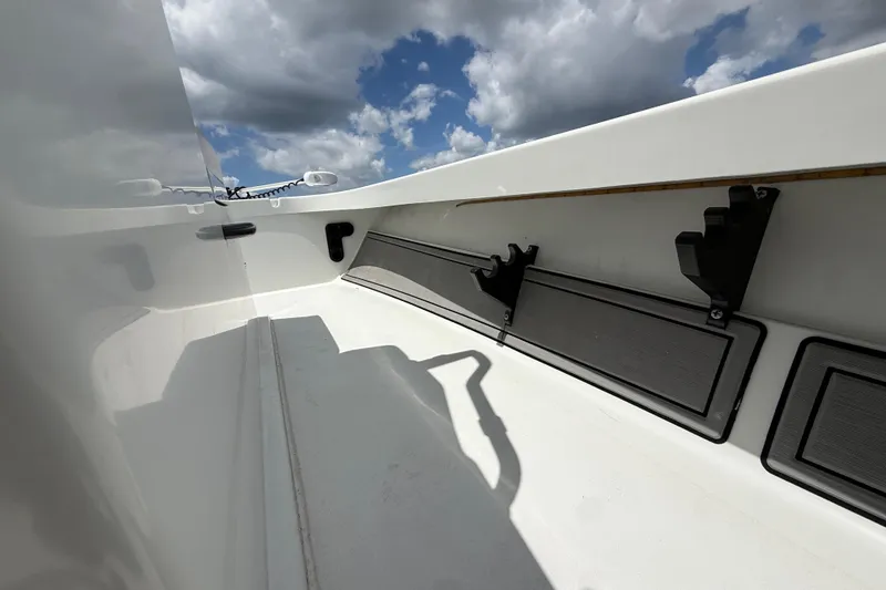 Slide: The Image of 2017 Beavertail Skiffs Lightning interior with rod holders, under a partly cloudy sky. - 17