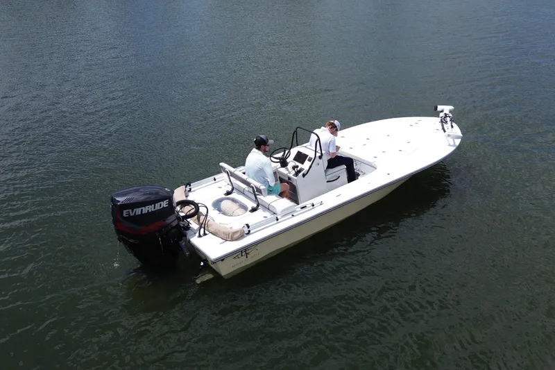Slide: The Image of 2017 Beavertail Skiffs Lightning boat on water with two passengers. - 2