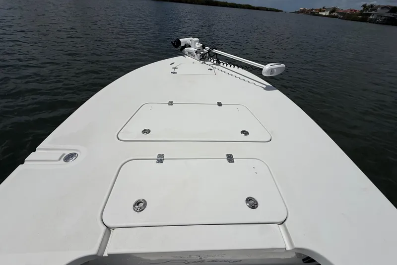 Slide: The Image of 2017 Beavertail Skiffs Lightning boat deck with storage compartments on calm water. - 20