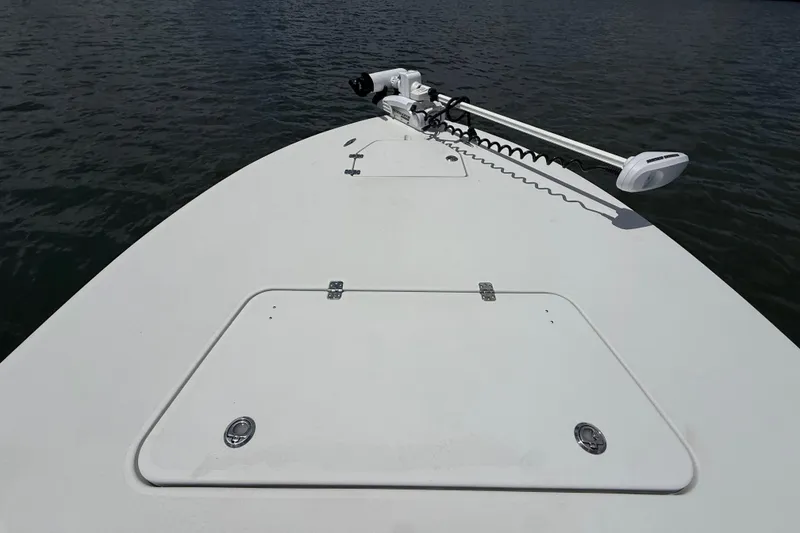 Slide: The Image of 2017 Beavertail Skiffs Lightning boat deck with trolling motor on calm water. - 22