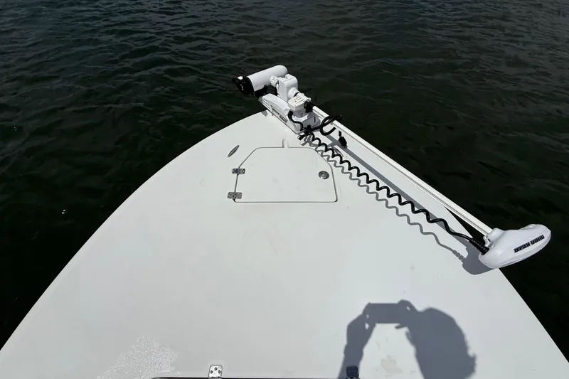 Slide: The Image of 2017 Beavertail Skiffs Lightning boat deck with trolling motor on calm water. - 24