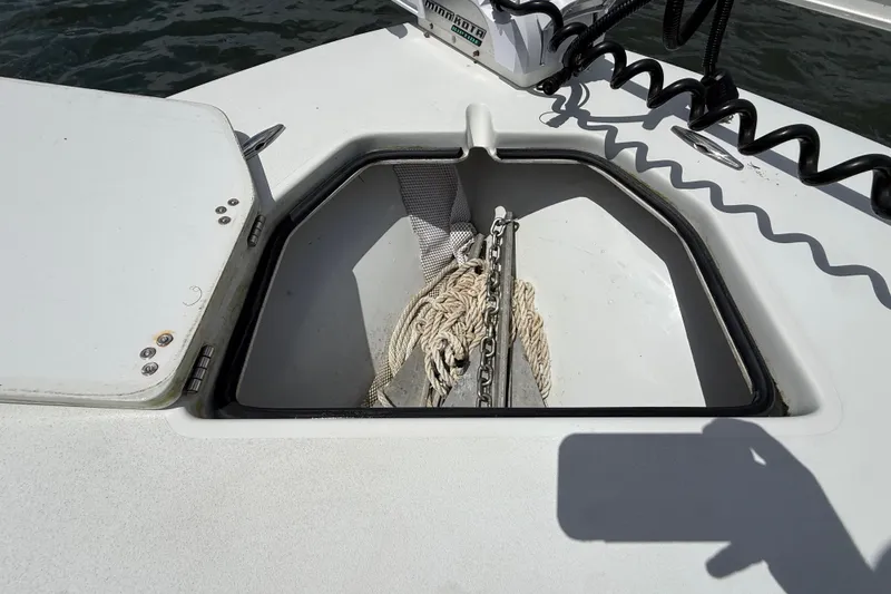 Slide: The Image of Open anchor compartment on 2017 Beavertail Skiffs Lightning boat, showing rope and chain storage. - 25