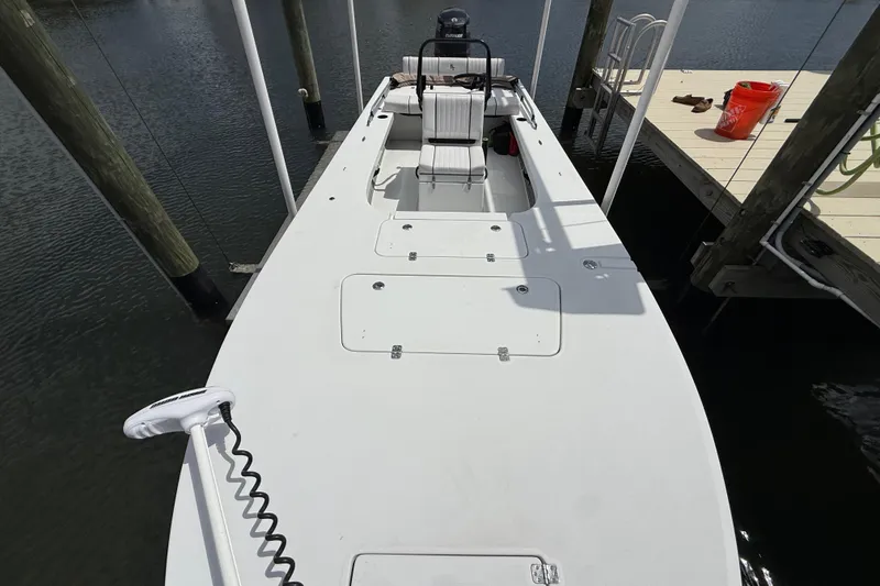 Slide: The Image of 2017 Beavertail Skiffs Lightning boat docked, showcasing spacious deck and seating. - 27