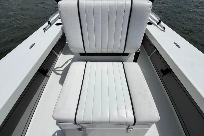 Slide: The Image of 2017 Beavertail Skiffs Lightning boat seat, white upholstery, on calm water. - 29