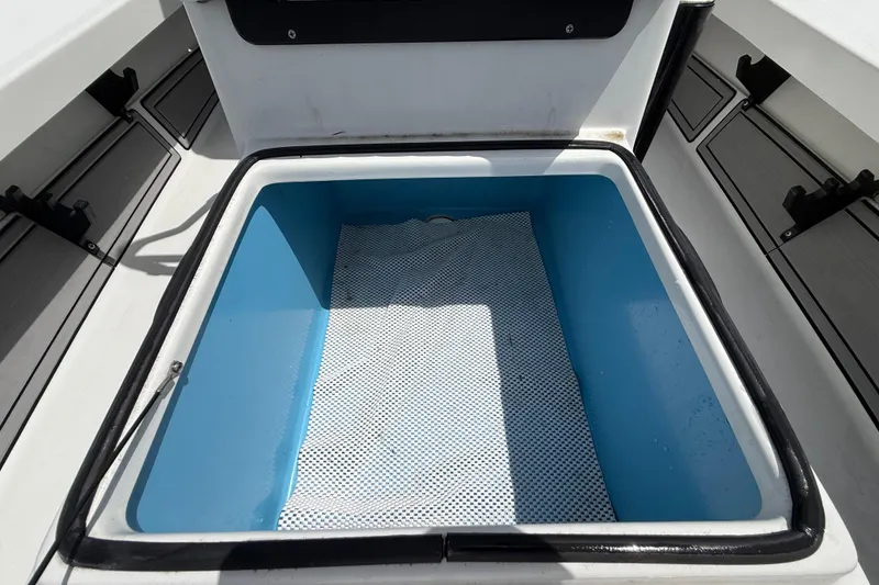 Slide: The Image of 2017 Beavertail Skiffs Lightning boat storage compartment with blue interior and non-slip mat. - 30