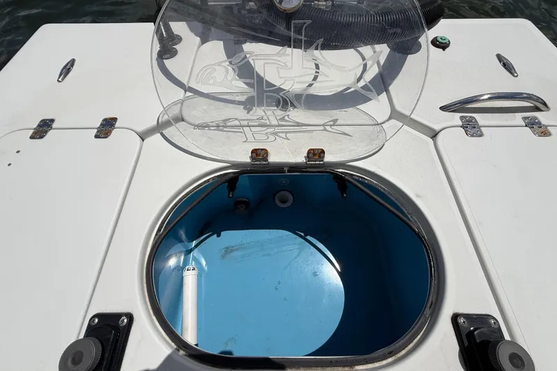 Slide: The Image of 2017 Beavertail Skiffs Lightning boat hatch with open lid, revealing blue interior. - 35