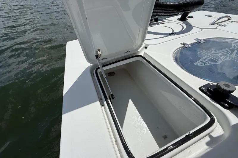 Slide: The Image of 2017 Beavertail Skiffs Lightning boat storage compartment open on water. - 39