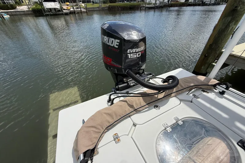 Slide: The Image of 2017 Beavertail Skiffs Lightning with Evinrude 150 engine docked by the water. - 45