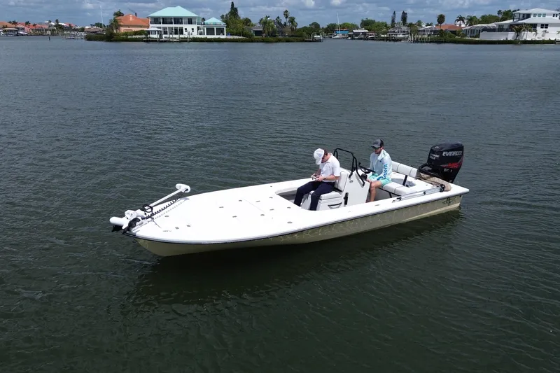Slide: The Image of 2017 Beavertail Skiffs Lightning boat on calm water with two passengers. - 6