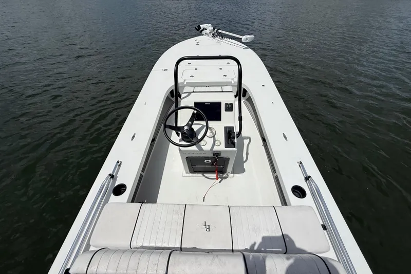 Slide: The Image of 2017 Beavertail Skiffs Lightning boat interior with steering wheel on calm water. - 8