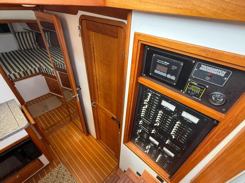 Slide: The Image of Interior of 2002 Legacy 34 Express boat with control panel and wooden flooring. - 25