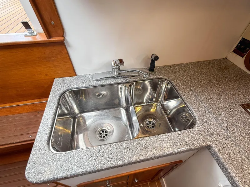 Slide: The Image of Stainless steel sink on Legacy 34 Express 2002 boat with granite countertop. - 29