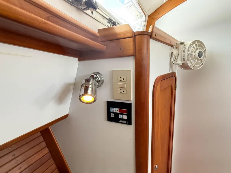Slide: The Image of Interior of 2002 Legacy 34 Express boat with wooden accents and lighting fixtures. - 36