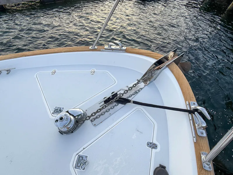 Slide: The Image of Bow of 2002 Legacy 34 Express boat with anchor and chain mechanism. - 47