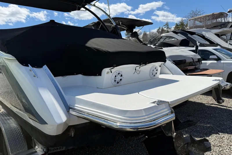 Slide: The Image of 2019 Cobalt R5 boat with covered deck, parked outdoors under a blue sky. - 15