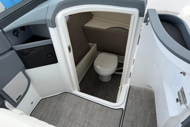 Slide: The Image of 2019 Cobalt R5 boat interior with compact marine toilet and storage area. - 6