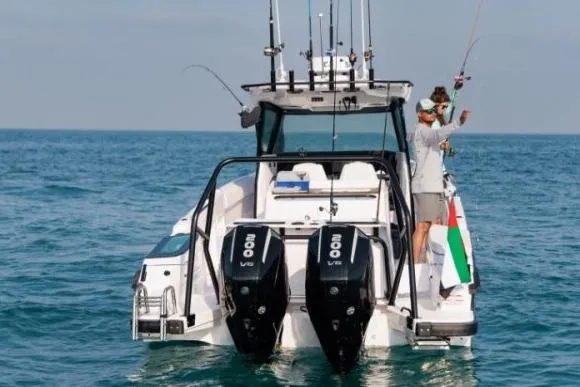 Slide: The Image of 2027 Axopar 29 CCX boat with dual engines, people fishing at sea. - 3