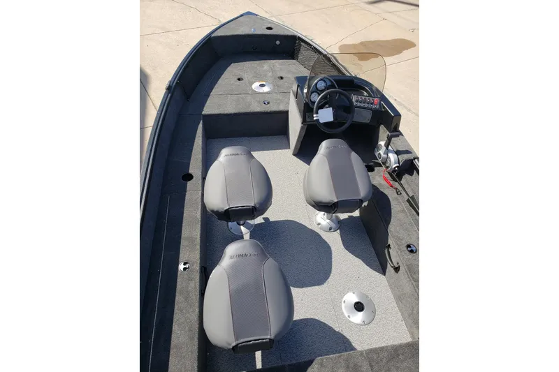 Slide: The Image of 2026 Alumacraft Classic 165 SC boat interior with steering console and seating. - 12