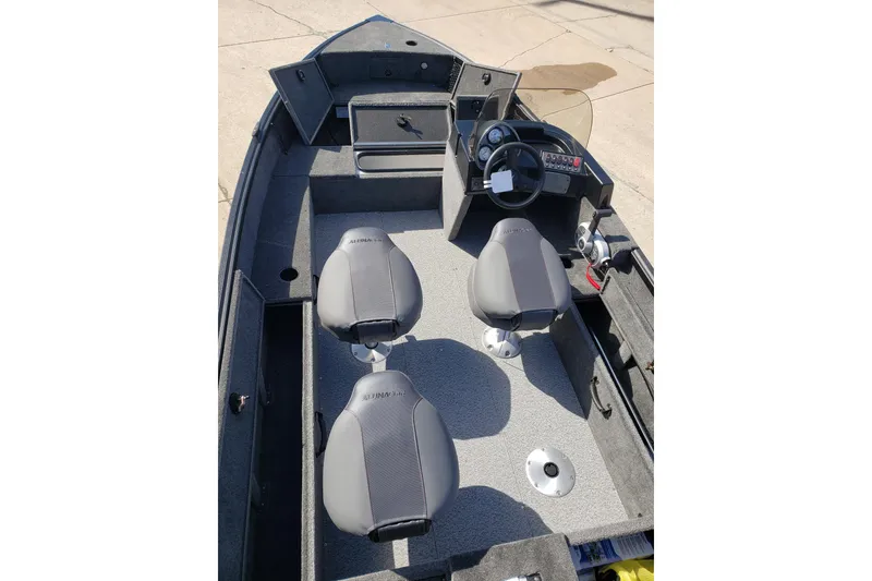 Slide: The Image of 2026 Alumacraft Classic 165 SC boat interior with seating and steering console. - 14