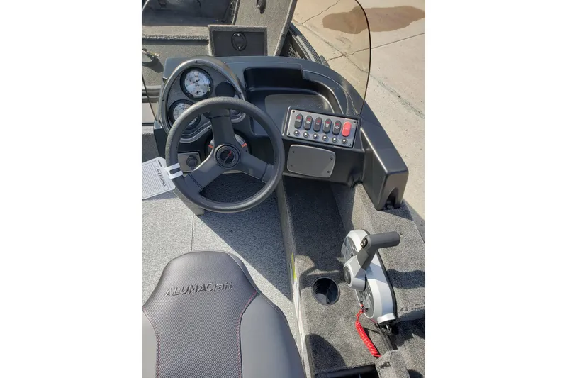 Slide: The Image of 2026 Alumacraft Classic 165 SC boat dashboard with steering wheel and control panel. - 15